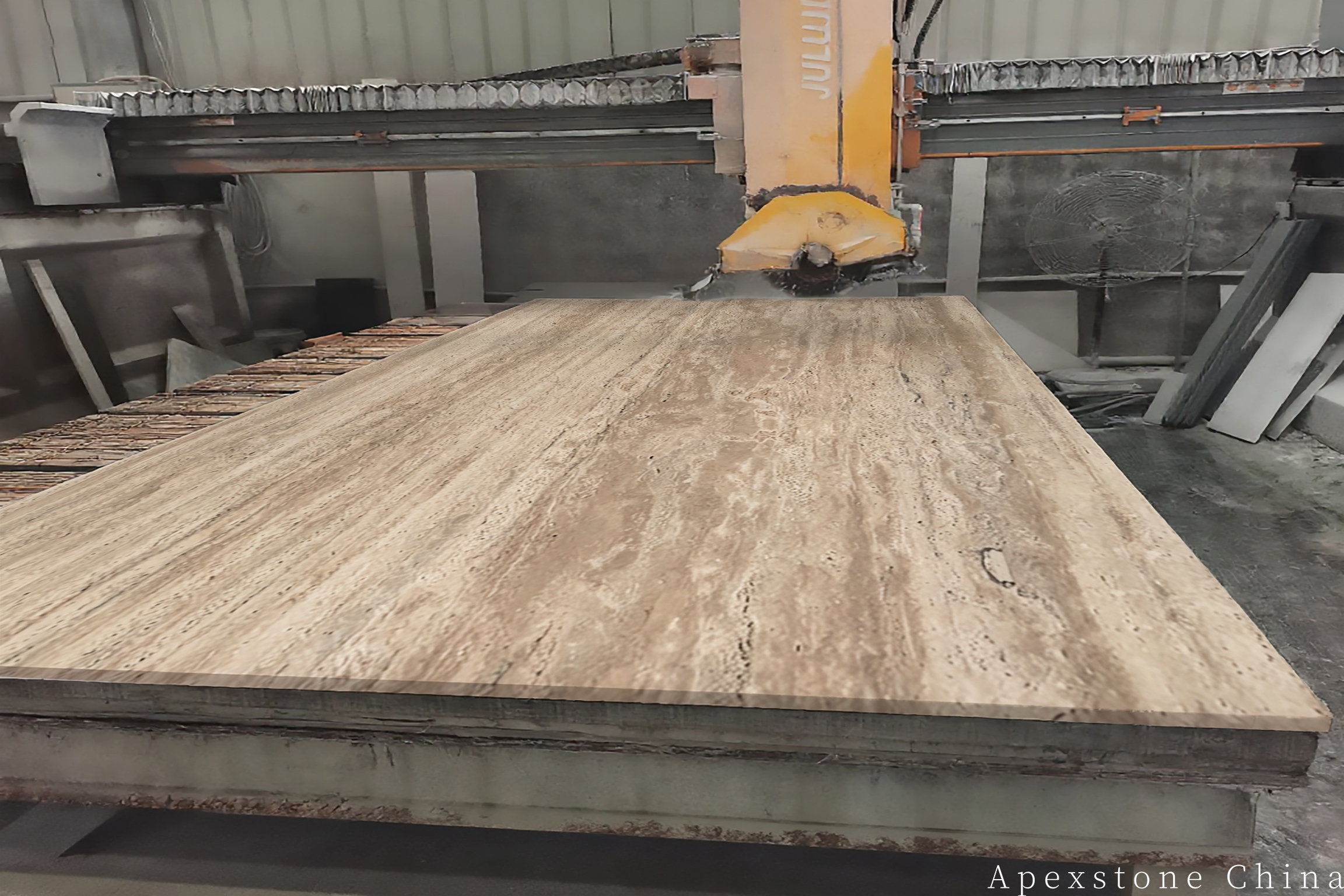 Travertine Romano slab being planned for precision cutting