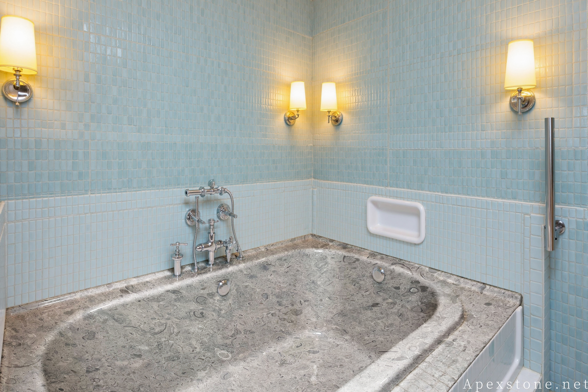 Portuguese Grey limestone shower space with solid stone tub installation