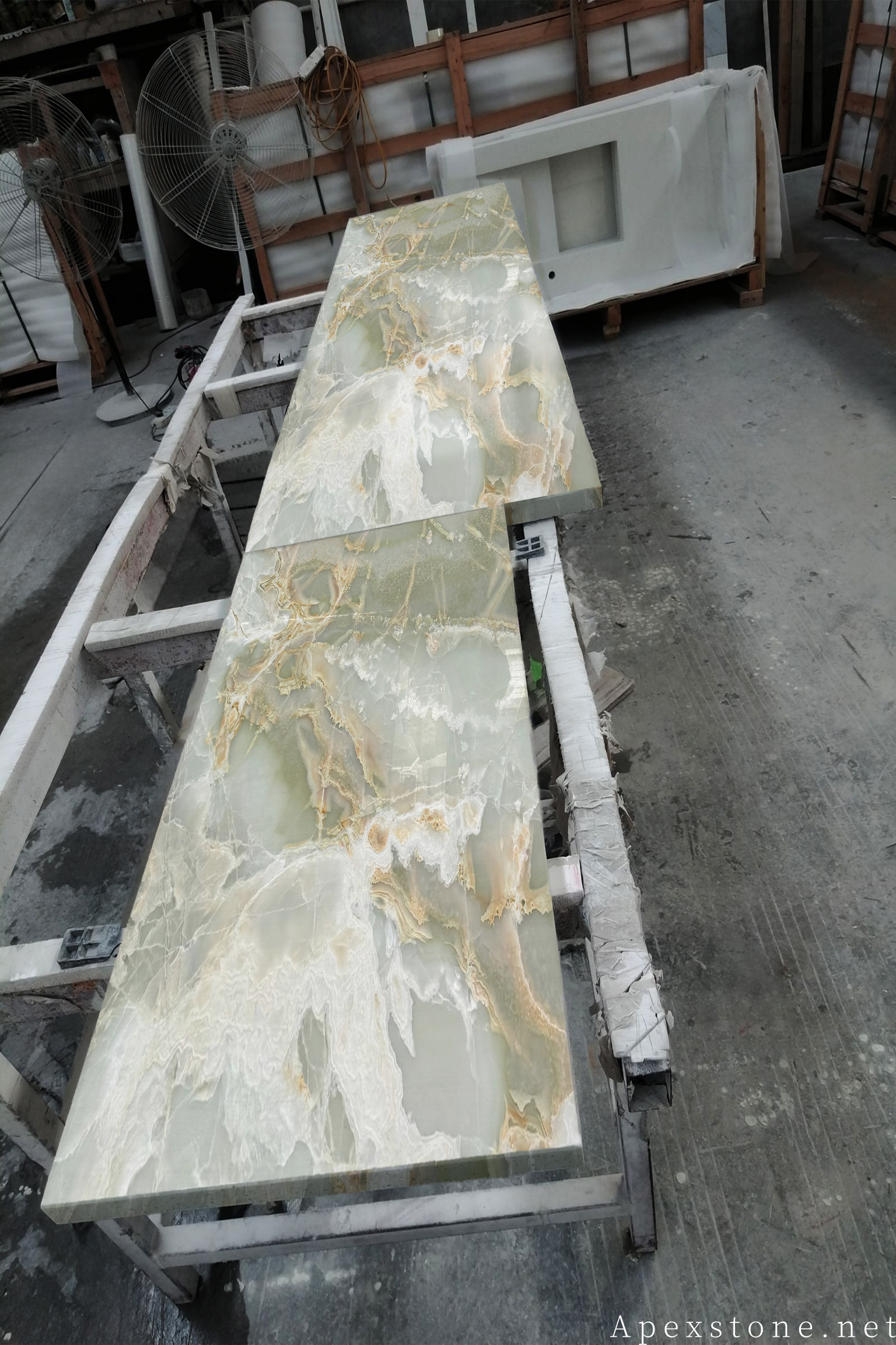 Green Onyx bar top with translucent backlit effect compared with Primavera Marble emerald surface