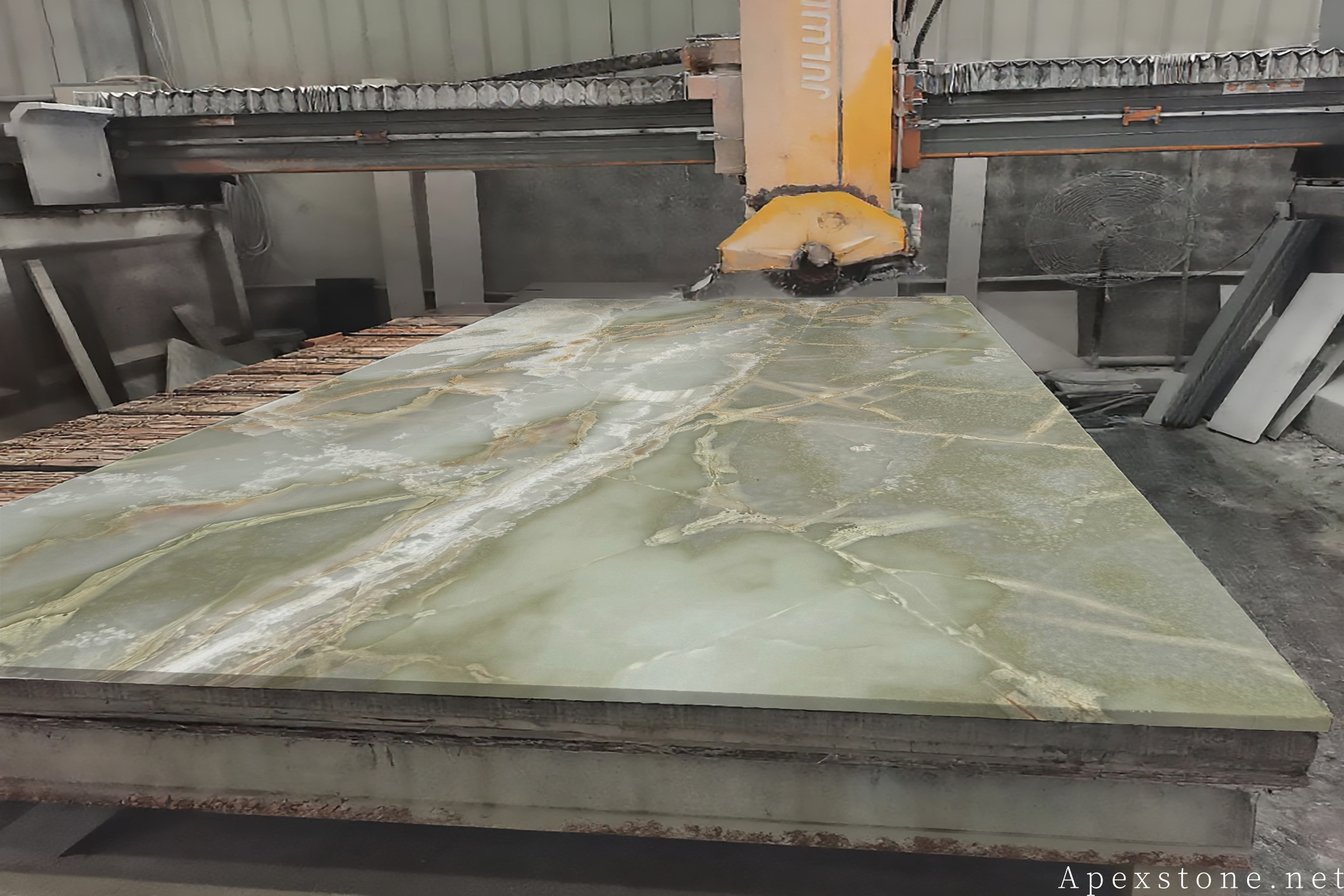 Green Onyx slab cutting on bridge saw